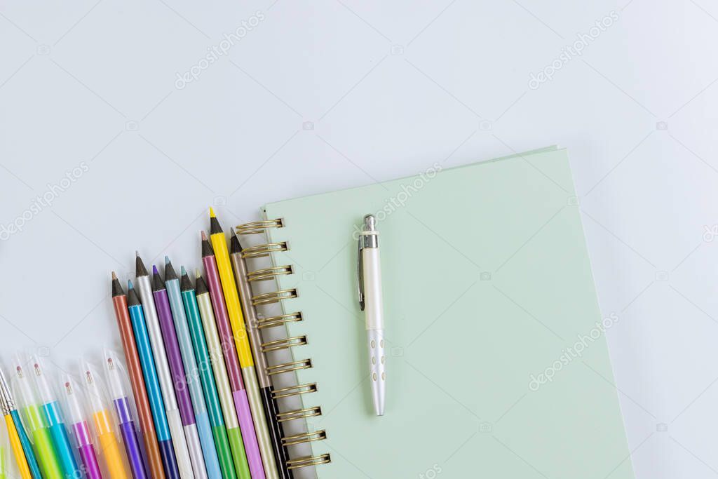 School times in assortment of various school supplies items on stationery equipment