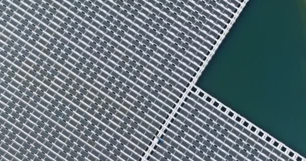 Panorama vista aérea de painéis solares flutuantes plataforma de células no belo lago energia elétrica alternativa renovável — Vídeo de Stock