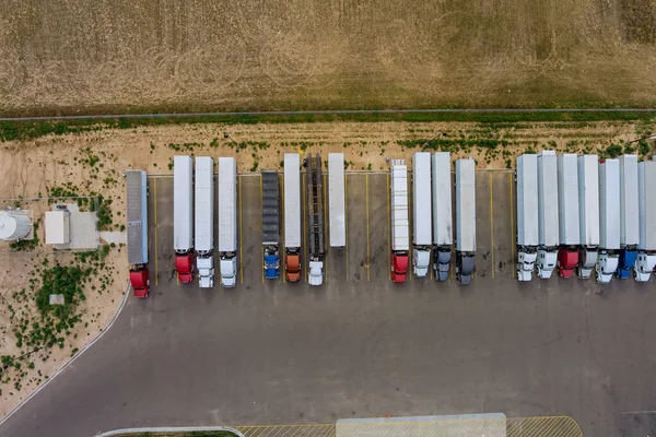 Aerial top view semi truck with cargo trailer car parking of truck rest area dock