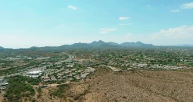 Flight with a drone over a with low houses in small Fountain Hills town near mountain desert a sunny day in Arizona USA