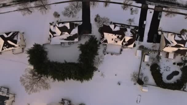 Vista aérea de pequeñas calles residenciales cubiertas de nieve durante el invierno y después del día nevado — Vídeo de stock