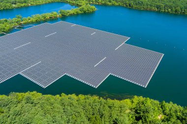 Floating solar panels platform on the beautiful lake renewable alternative electricity energy of panorama aerial view clipart