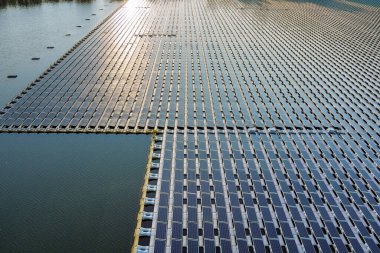 Aerial view of lake in renewable alternative electricity on floating solar panels cell platform clipart