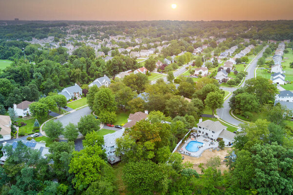 Aerial view of single family homes, a residential district Sayreville near pond in New Jersey US
