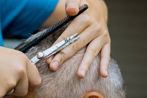 A man is around in a home haircut styling in men