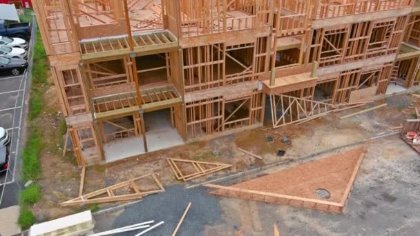 Framing of under construction wooden house building frame structure on new development — Stock Video