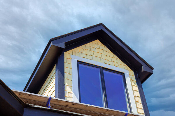 Newly built house showcases modern architecture with large windows unique roof design against