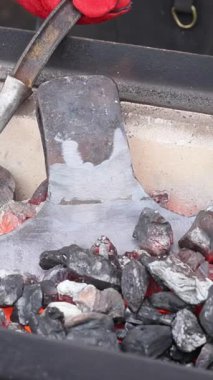 Demirciler geleneksel metal çalışma tekniklerini balta yapımında ısıtmalı araçlar kullanarak kullanırlar..