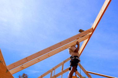 İnşaatçı montaj günü çatıya kirişler kuruyor.