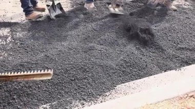 İşçiler, ticari alanda geniş süpürgeli yeni asfalt döşüyorlar..