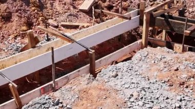 Wooden forms are set in place at construction site during curbed is concrete installation to sidewalk