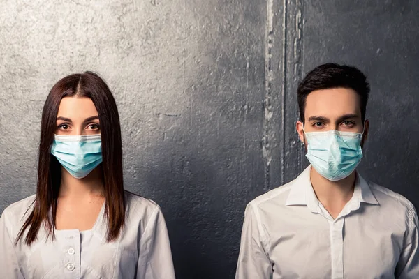 Doctor nurse patient in personal protective equipment. Healthcare concept. Couple wear white shirt medical gown, blue face disposable mask. Coronavirus pandemic. Epidemic disease.