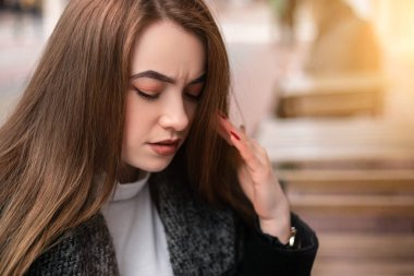 Elegant busy pretty woman sitting outside street cafe coffee shop stressed confused have headache migraine. Confident cute female businesswoman thinking about her small business. Copy space.