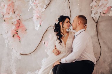 Karı koca stüdyodaki fotoğraf çekiminde kucaklaşıyorlar. Evlenen gelin ve damat nişanlarını kutluyorlar. Romantik aşıklar, yeni evli çiftler, kopyalama alanı..