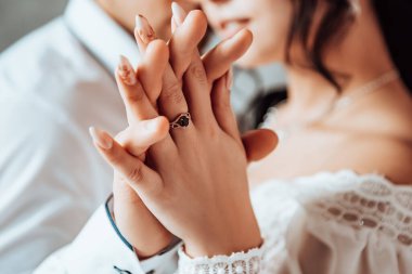 Gelin ve damat parmağına alyans takıyor. Karı koca pencere kenarındaki iki sevgili düğün törenini kutluyorlar. Çiftleşme romantik yeni evliler kapalı alanda, kopyalama alanı.