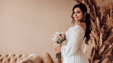 Profil tarafı kadın evli gelin nişanı kutluyor. Beyaz elbiseli kadın düğün buketini tutuyor güzel çiçekler. Üreme romantik kadın kapalı, kopyalama alanı.