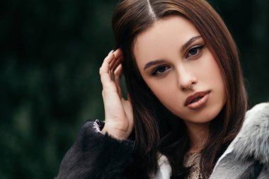 Moda kapanış portresi oldukça kendinden emin bir kadın sokak Avrupa şehrinin dışında poz veriyor moda çevre dostu yapay kürk ceket kışlık giysiler burun delici büyük dudaklar