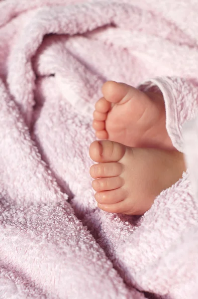 Pieds de bébé sous couverture — Photo