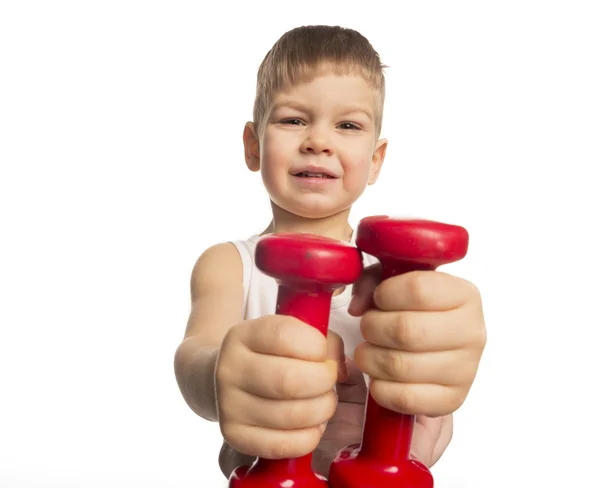 Little boy picks up a dumbbell — Stock Photo, Image