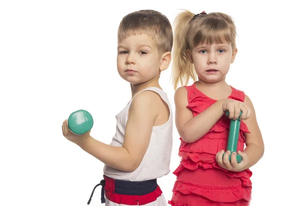 Little boy and girl lift dumbbells Stock Photo