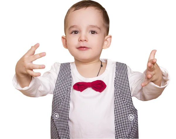 Niño pequeño con un traje a cuadros y pajarita lanza sus manos — Foto de Stock