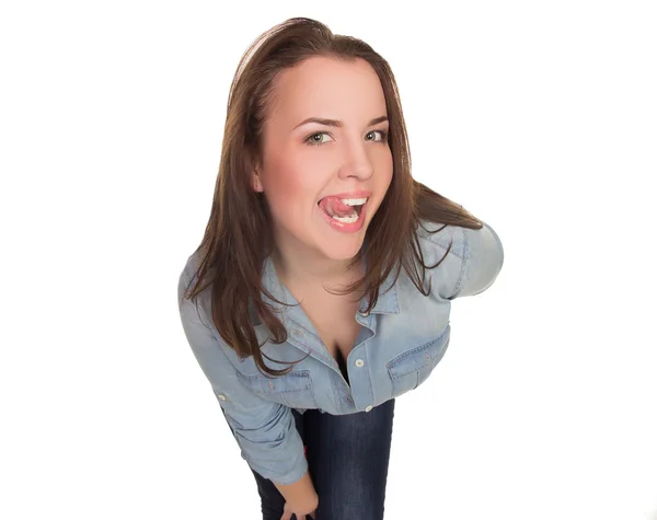 Girl in a denim shirt shows tongue — Stock Photo, Image