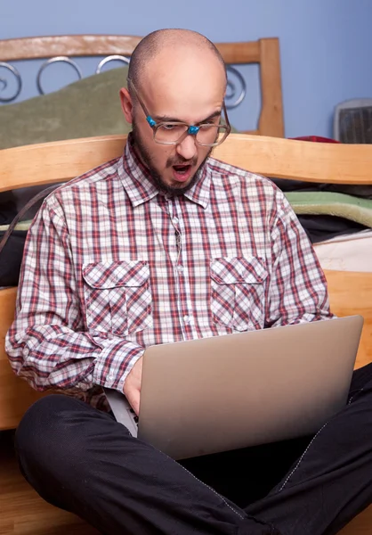 Surprised nerd with a laptop — Stock Photo, Image