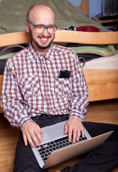 Smiling nerd with a laptop — Stock Photo, Image