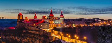 Kamianets-Podilskyi, Ukrayna 01.07.2020. Bir kış gecesi Kamianets-Podilskyi kalesinin panoramik manzarası