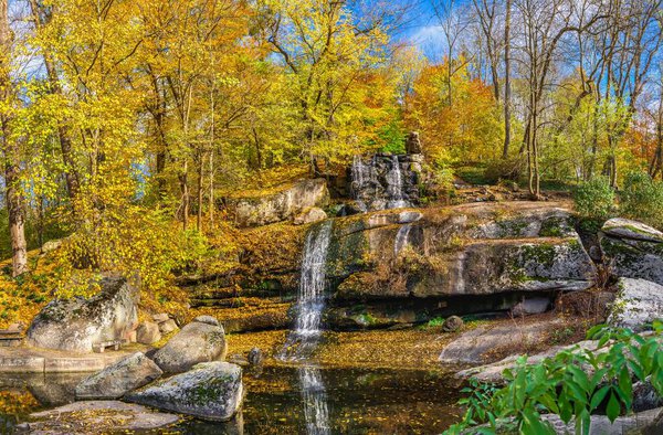 Valley of the Giants and waterfall in the Sofievsky arboretum or Sofiyivsky Park in Uman, Ukraine, on a sunny autumn day