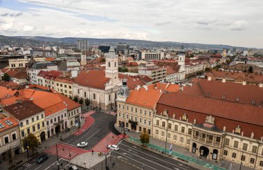 Cluj-Napoca, Romanya - Ekim 18.2025 Romanya 'nın Cluj-Napoca kentinin tarihi merkezi, bulutlu bir gökyüzü altında geleneksel kırmızı başlıklı çatılar, şehir sokakları ve St. Michael Kilisesi' ni gösteriyor.