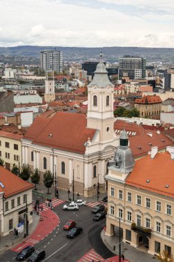 Cluj-Napoca, Romanya - Ekim 18.2025 Romanya 'nın Cluj-Napoca kentinin tarihi merkezi, bulutlu bir gökyüzü altında geleneksel kırmızı başlıklı çatılar, şehir sokakları ve St. Michael Kilisesi' ni gösteriyor.