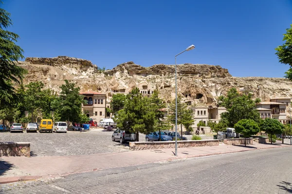 卡帕多细亚，土耳其-2014 年 6 月 25 日: 崖"洞"为背景的照片现代建筑房屋的老于尔居普镇 — 图库照片