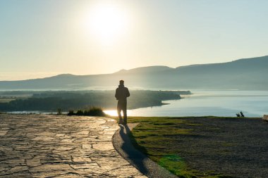Siluet dağın tepesinde güneşin doğuşunu izliyor. Waterton, AB