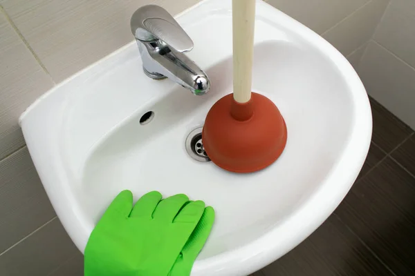 The main subject is out of focus, Solving Common Household Drain Problems, symptoms Solutions blockage plumbing bathroom sink unclog plunger force cup