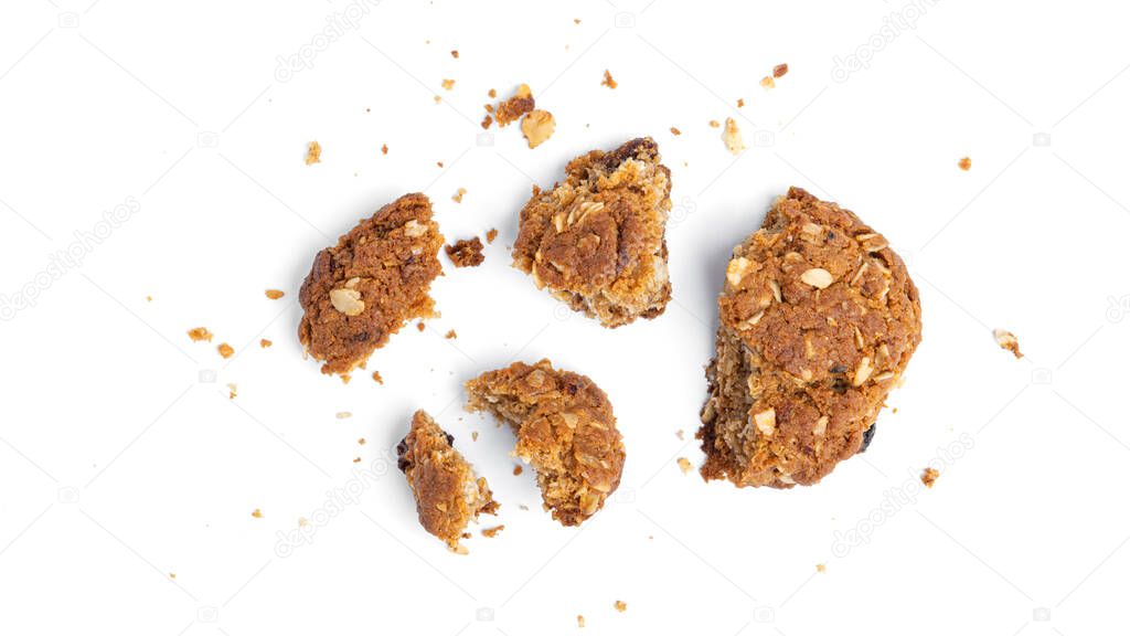 Oatmeal cookies with raisins and coconut on a white background. Crumbs. View from the top. High quality photo