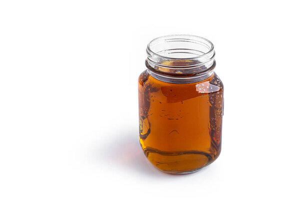 Apple juice in mason jar on a white background. 