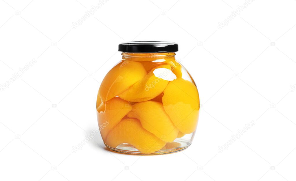 Peaches canned in glass jar. Sweet peaches in syrup isolated on white background.