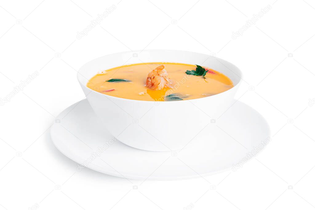 Soup with shrimps in a white deep dish isolated on a white background. Thai soup with seafood. Thai tom yum soup