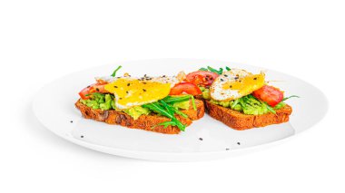 Rye bread sandwich with guacamole, arugula, tomatoes and quail egg isolated on a white background. Bruschetta with avocado. Healthy breakfast.