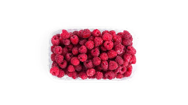 Raspberry isolated on a white background. Raspberries in plastic container. — Stock Photo, Image