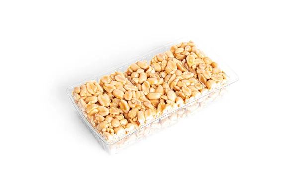 Peanut brittle isolated on white background. Peanuts in caramel. Natural candy bar. — Stock Photo, Image