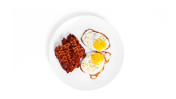 Fried eggs with fried bacon isolated on a white background. — Stock Photo, Image