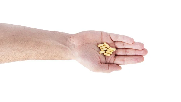 Vita piller i handen isolerad på en vit bakgrund. — Stockfoto