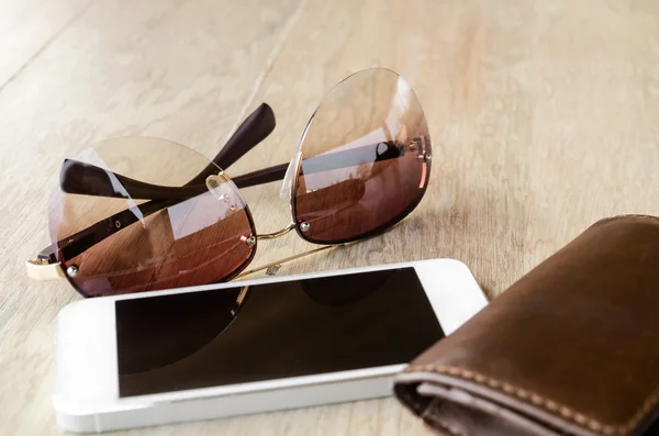 A set of tinted sunglasses and smartphone — Stock Photo, Image