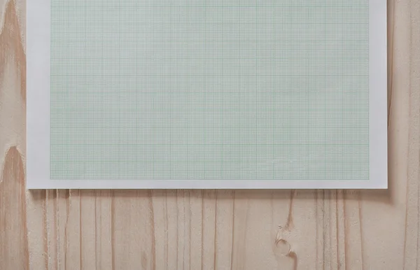 Papel gráfico na mesa de madeira — Fotografia de Stock