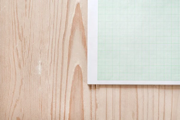 graph paper on wooden desk