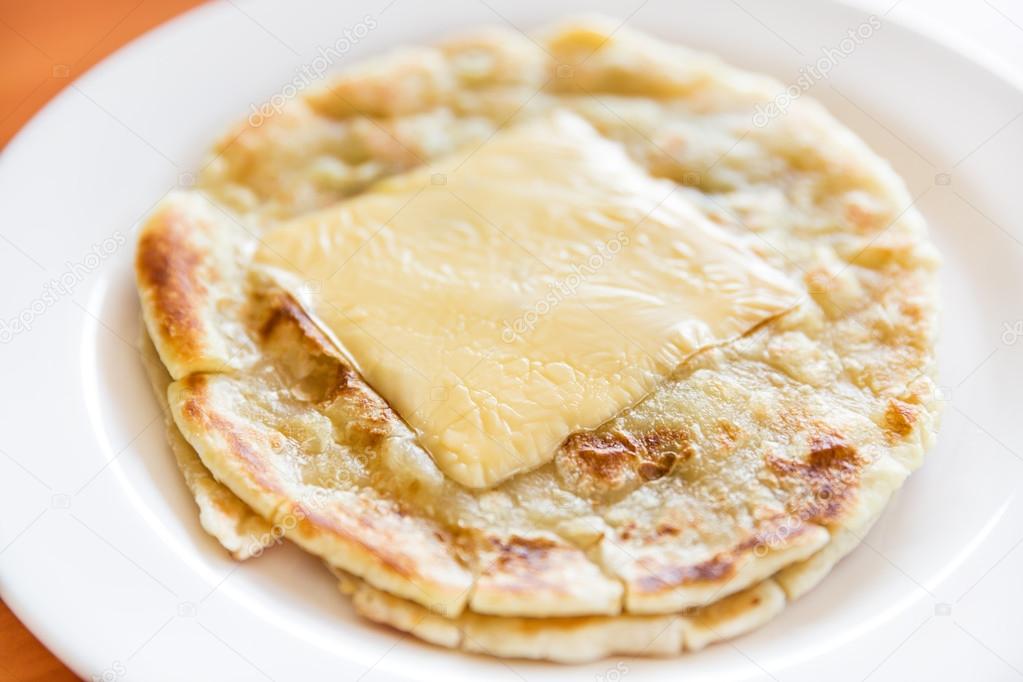 Roti prata with chesse on plate