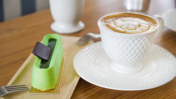 Cup of cappuccino on the table in a cafe — Stock Photo, Image