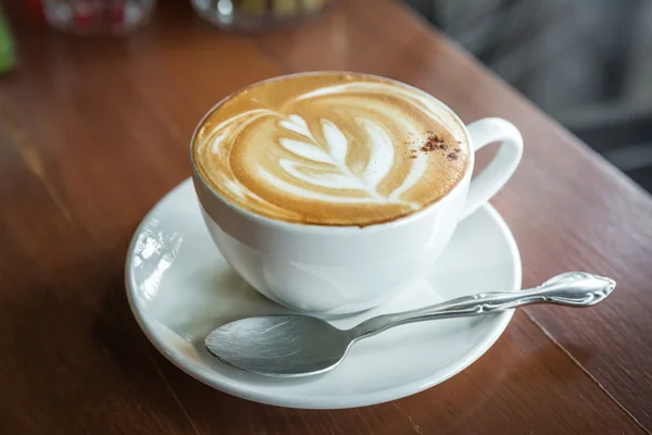 cup of coffee on brown wooden table